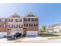 Attractive brick townhome with a two-car garage, providing a blend of modern design and comfortable living at 3080 Westpoint Cir, Snellville, GA 30078