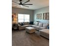 Comfortable living room with a large sectional sofa and a ceiling fan at 409 Ruths Blvd, Woodstock, GA 30188