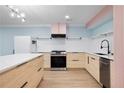 Bright modern kitchen with stainless steel appliances, center island, light wood cabinets, and stylish decor at 845 Lake Hollow Sw Blvd, Marietta, GA 30064