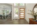 Inviting entryway with modern wood door and view to dining at 110 Fairway Ridge Dr, Johns Creek, GA 30022