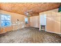 Spacious fixer-upper room featuring two windows, ceiling fan, and unique ceiling detail at 2180 Rexford Dr, Decatur, GA 30034
