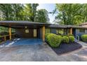 Large covered carport featuring painted flooring and wood accents and access to the home's front door at 3193 Trasher Cir, Decatur, GA 30032
