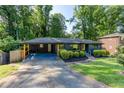 A ranch-style home features a covered carport, manicured landscaping, and a freshly painted front exterior at 3193 Trasher Cir, Decatur, GA 30032