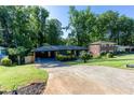 A charming single-story home boasts a covered carport, healthy landscaping, and a green front yard at 3193 Trasher Cir, Decatur, GA 30032