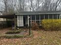 Charming single-story home with a screened-in porch and cozy carport, nestled among trees at 4201 Lindsey Dr, Decatur, GA 30035