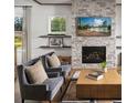Cozy living room featuring a stone fireplace and comfortable seating at 4815 Ramblewood Dr, Cumming, GA 30028