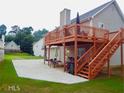 Backyard featuring a spacious deck and stairs leading to a patio area perfect for outdoor entertaining at 95 Revere Dr, Fairburn, GA 30213
