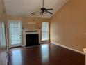 Cozy living room with a fireplace, ceiling fan, and door to the outside at 95 Revere Dr, Fairburn, GA 30213