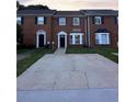 Traditional brick townhouse with a well-maintained front yard and private driveway at 1507 Paces Ferry North Se, Smyrna, GA 30080