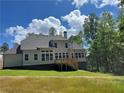 Expansive backyard with a charming deck, perfect for outdoor entertaining, surrounded by lush greenery and blue skies at 3730 Reserve Overlook (Lot 8) Way, Cumming, GA 30041