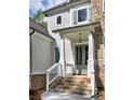 Inviting front entry with stone steps, a light gray door, and stone and siding accents at 3730 Reserve Overlook (Lot 8) Way, Cumming, GA 30041