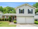Charming two-story home with gray siding, blue shutters, and a well-manicured lawn at 734 Kilkenny Cir, Lithonia, GA 30058