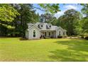 Lovely single-story home with a manicured lawn and mature trees, creating a peaceful and inviting atmosphere at 836 Palmetto Tyrone Rd, Sharpsburg, GA 30277