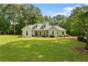 Beautiful single-story home featuring a large green lawn and surrounded by mature trees, in a serene setting at 836 Palmetto Tyrone Rd, Sharpsburg, GA 30277