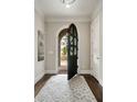 Elegant foyer with arched doorway, hardwood floors and stylish area rug at 1849 Rock Springs Ne Ln, Atlanta, GA 30324