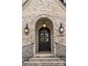 Arched front door with decorative wreath and updated exterior lighting at 1849 Rock Springs Ne Ln, Atlanta, GA 30324