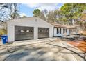 Spacious detached two-car garage next to a well maintained, ranch-style home at 2401 Phillips Rd, Lithonia, GA 30058