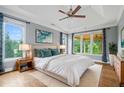 Serene main bedroom featuring tray ceilings, natural light, and a relaxing atmosphere at 2455 Ivey Oaks Rd, Cumming, GA 30041