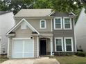 Inviting two-story home featuring neutral siding, a well-kept lawn, and an attached garage at 556 Poplar Bnd, Canton, GA 30114