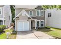 Charming two-story home featuring a one-car garage and well-maintained front yard at 556 Poplar Bnd, Canton, GA 30114
