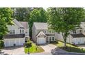 Neighborhood view of cozy two-story home with single-car garage and driveway in a well-maintained community at 556 Poplar Bnd, Canton, GA 30114