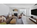 Living room featuring wood-style floors, comfortable seating, and a fireplace at 1303 Wingate Way, Atlanta, GA 30350