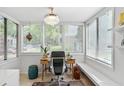Bright and airy sunroom with large windows, creating a perfect home office space at 1303 Wingate Way, Atlanta, GA 30350