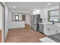 Open-concept kitchen with stainless steel appliances, white cabinetry, and a view into an adjacent room enhancing the flow at 2664 Olive Springs Se Rd, Marietta, GA 30060