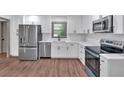 Modern kitchen featuring white cabinets, stainless steel appliances, and quartz countertops, offering a clean and stylish look at 2664 Olive Springs Se Rd, Marietta, GA 30060