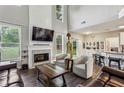 Open-concept living room with a fireplace and views of the kitchen at 321 Woodbrook Crst, Canton, GA 30114