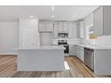 Modern kitchen featuring stainless steel appliances, a large island, and granite countertops at 867 Pensive Run, Dacula, GA 30019