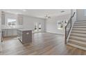 Open-concept living space with hardwood floors, modern staircase and access to the backyard at 867 Pensive Run, Dacula, GA 30019