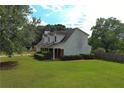 View of the well-maintained lawn and the side of the two-story house at 1012 Gloria Grand Blvd, Mcdonough, GA 30252