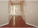 Inviting hallway with hardwood floors, classic wainscoting, and a view of the bright front entrance at 3350 Cooper Woods Dr, Loganville, GA 30052