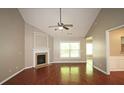 Spacious living room boasts hardwood floors, a fireplace, and plenty of natural light from the bright window at 3350 Cooper Woods Dr, Loganville, GA 30052