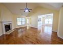 Spacious living room with hardwood floors, fireplace, and abundant natural light from large windows at 3350 Cooper Woods Dr, Loganville, GA 30052