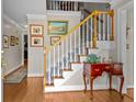 Elegant entryway with hardwood floors, staircase, and decorative furnishings at 3510 Smoke Rise Way, Lawrenceville, GA 30044