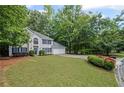 Traditional-style home with a two-car garage and a neatly landscaped yard in a lush setting at 3927 Collier Nw Trce, Kennesaw, GA 30144