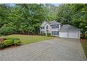 Traditional two-story home featuring a long driveway and an attached two-car garage at 3927 Collier Nw Trce, Kennesaw, GA 30144