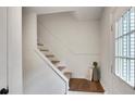 Bright entryway with a staircase, white walls, wood-look flooring and a stylish accent vase at 4368 Heritage Glen Ct, Marietta, GA 30068