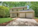 Home with a large front lawn, two car garage, and complementary green shutters at 4368 Heritage Glen Ct, Marietta, GA 30068
