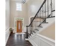 Bright foyer with tall ceilings, wood floors, and staircase with detailed banister at 5041 Corinault Nw Pl, Acworth, GA 30101