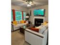 Comfortable living room with fireplace, mounted TV, and modern sofas with colorful pillows at 1270 Heritage Lakes Dr, Mableton, GA 30126