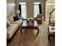 Cozy living room featuring a plush sofa, patterned armchair, and decorative coffee table at 1270 Heritage Lakes Dr, Mableton, GA 30126