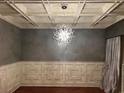 Elegant dining room with coffered ceilings, decorative lighting fixture, and wainscoting at 2785 Old Sewell Rd, Marietta, GA 30068