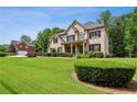 Charming brick home with lush green lawn, beautiful shrubs, and well-maintained landscaping at 2785 Old Sewell Rd, Marietta, GA 30068