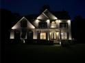 Well-lit home exterior featuring a brick facade, landscaped front yard, and inviting entrance at night at 2785 Old Sewell Rd, Marietta, GA 30068