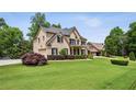 Traditional two-story brick home on a large lot with lush landscaping and a side-entry garage at 2785 Old Sewell Rd, Marietta, GA 30068