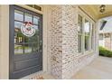Close up of the front door and brick exterior with a custom wreath accenting the welcoming entrance at 3750 Sweeting St, Cumming, GA 30041