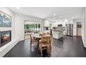 Open kitchen and dining area with a fireplace, stainless steel appliances, and access to a screened-in porch at 500 Read Ln, Atlanta, GA 30328